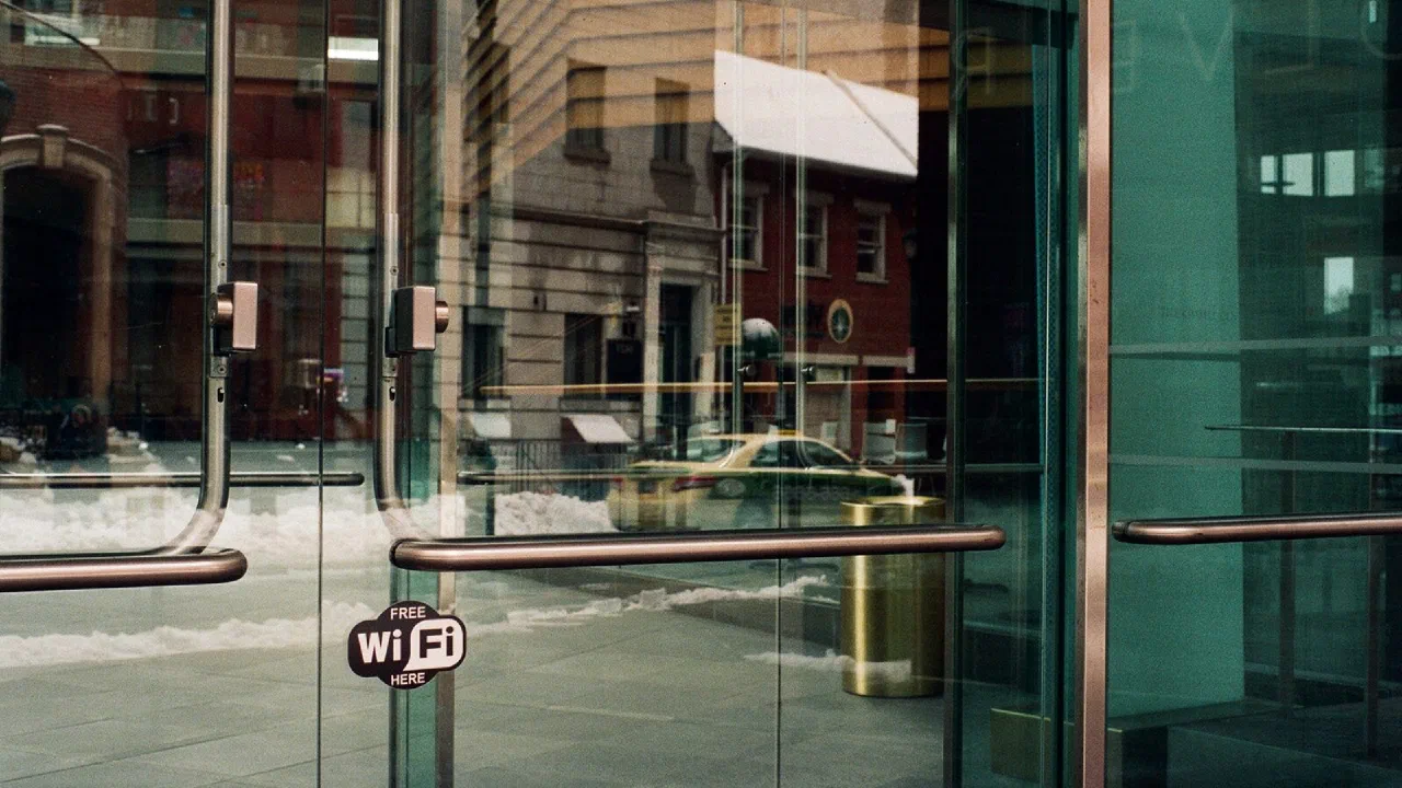 glass double doors of a storefront seen from the pavement