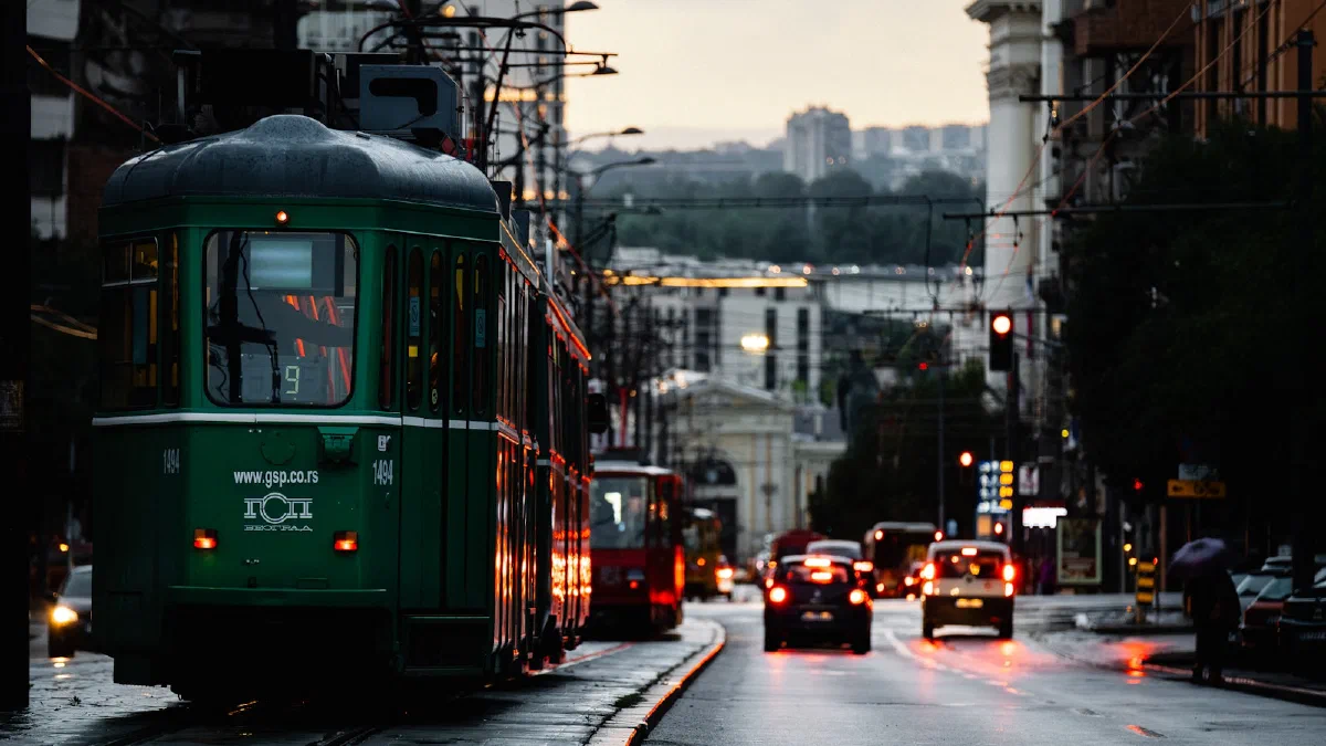 a city street with traffic running between tall apartment blocks